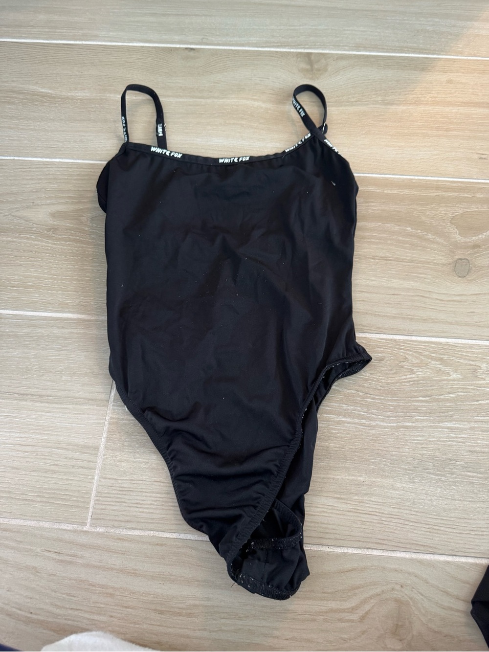 White Fox Boutique Black One-Piece Bodysuit with Logo Trim